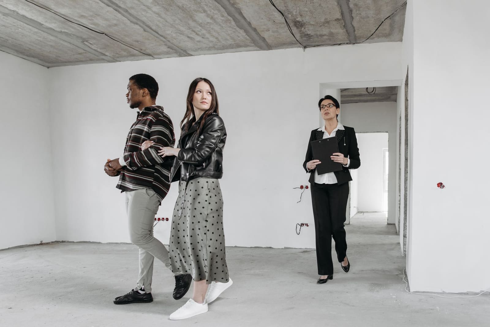 Jeune couple visitant une location appartement lumineuse avant signature du bail